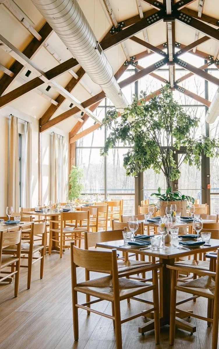 The soaring timber-framed barn dining room at The Dixboro Project